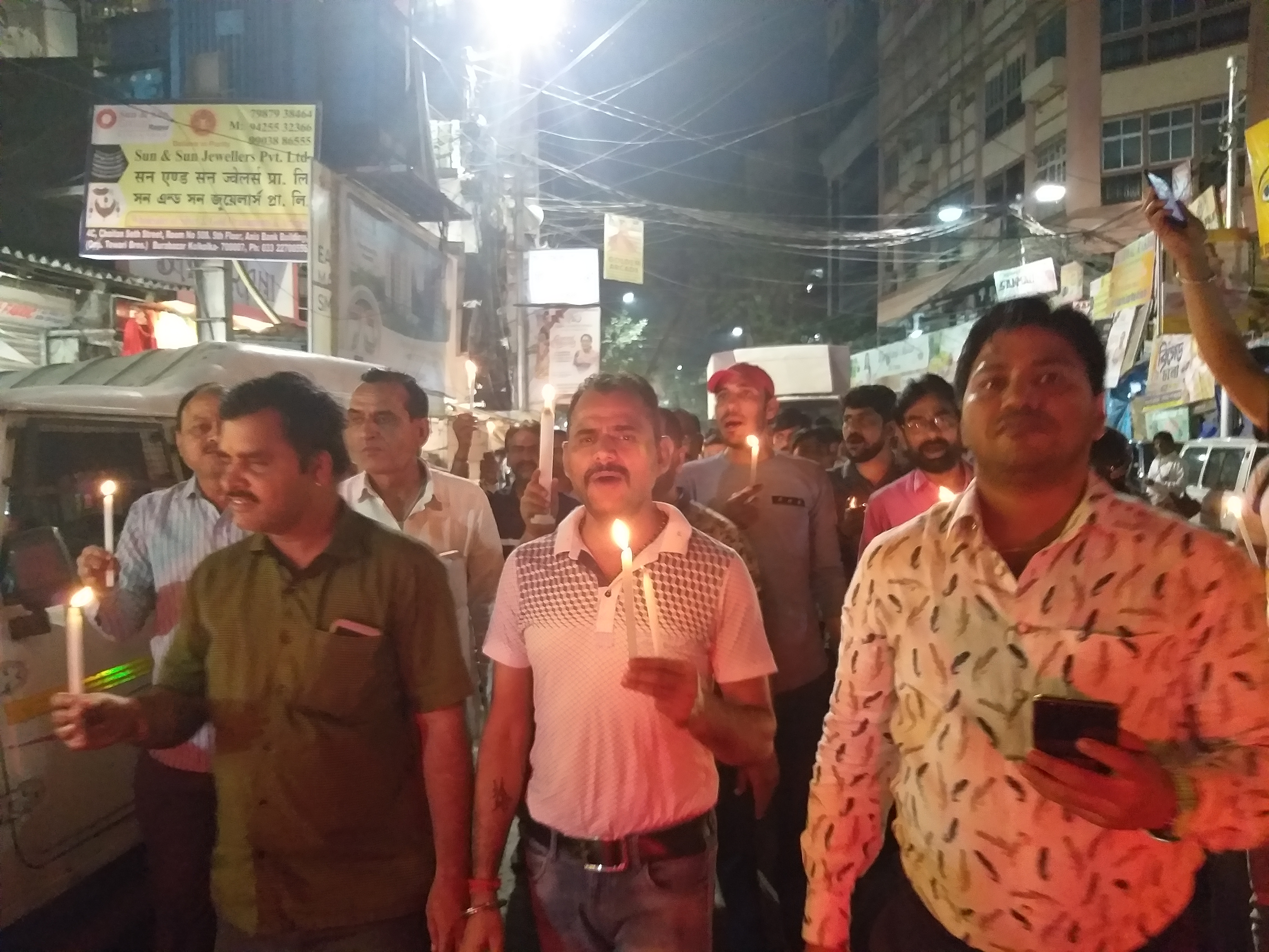 Candle march by businessmen